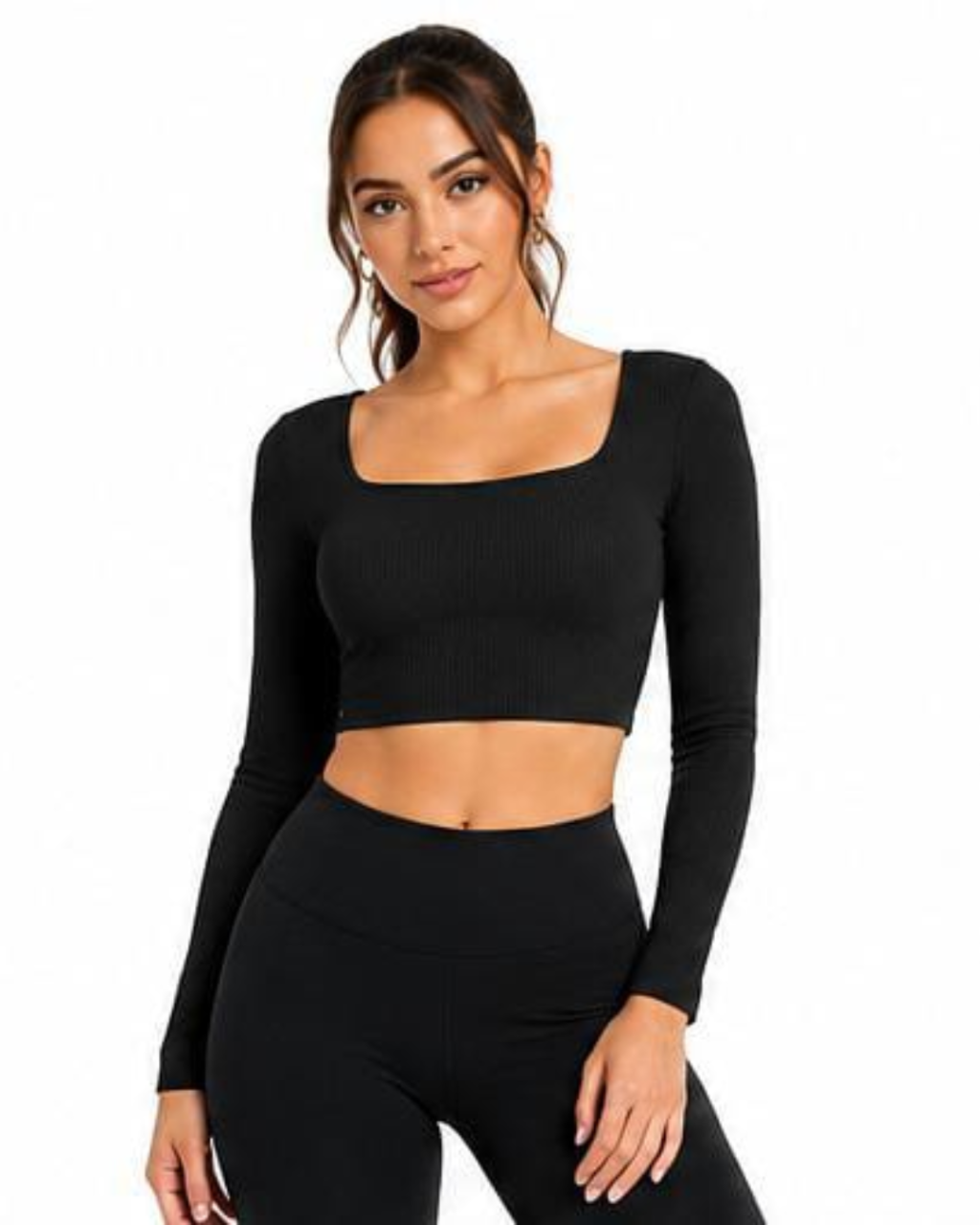 A woman modeling a black long-sleeve ribbed crop top with a square neckline and matching black high-waisted leggings against a plain white background.