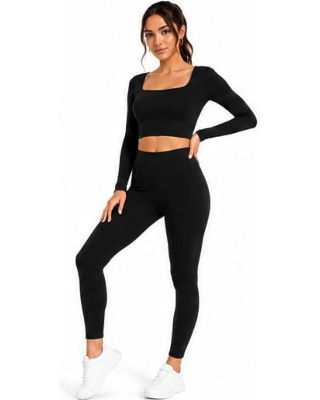 A woman modeling a matching black activewear set consisting of a long-sleeve crop top with a square neckline and high-waisted leggings, paired with white sneakers, against a plain white background.