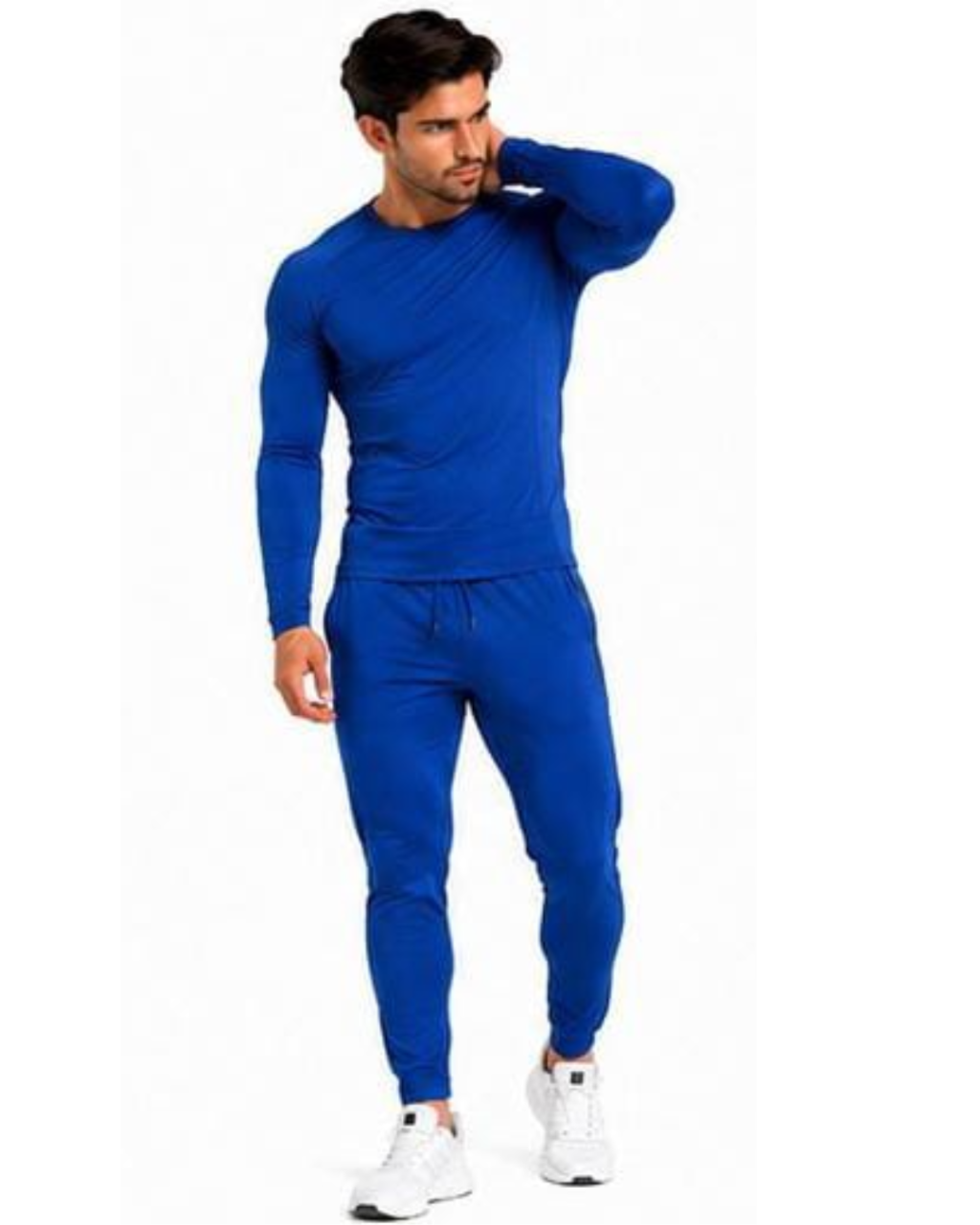 A man modeling a matching royal blue long-sleeve athletic top and jogger pants set, paired with white sneakers, against a plain white background.