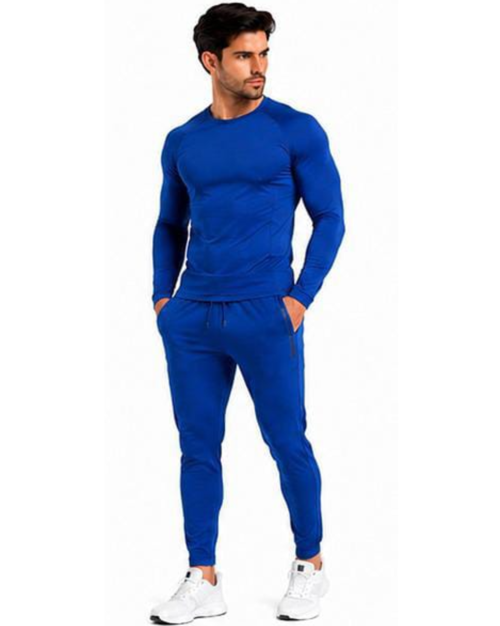 A man modeling a matching royal blue long-sleeve athletic top and jogger pants set, paired with white sneakers, against a plain white background.