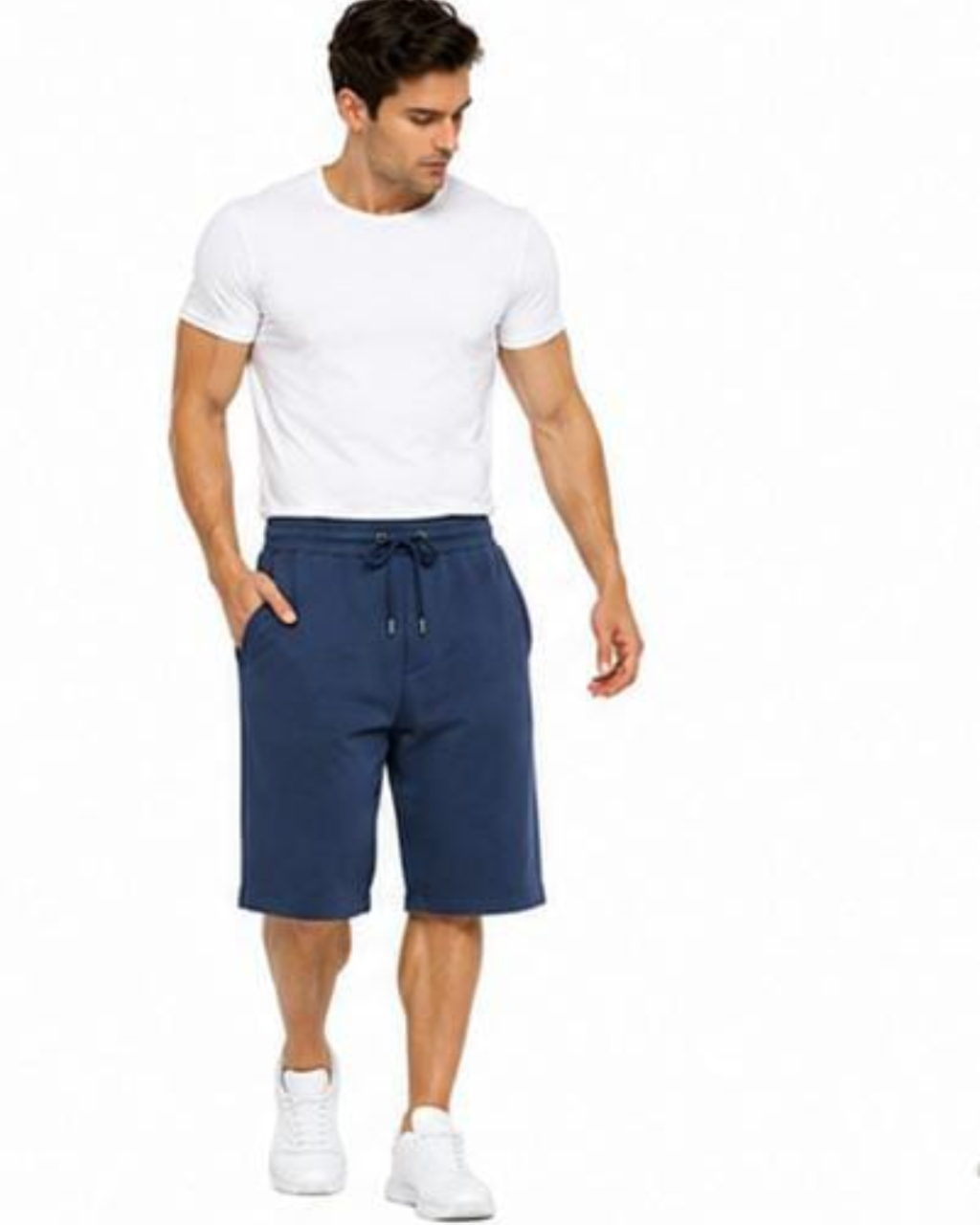 A man modeling a white crew-neck t-shirt and navy blue drawstring shorts against a plain white background.