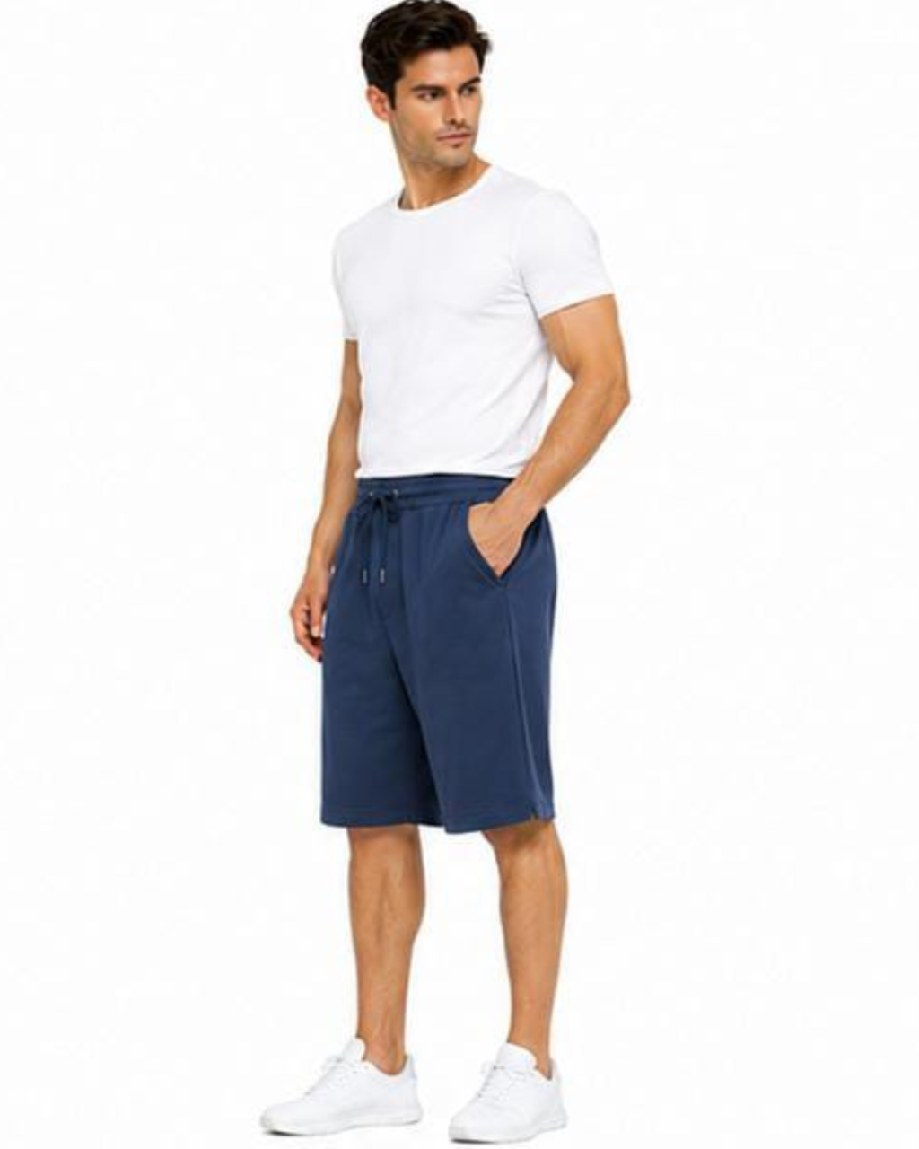 A man modeling navy blue drawstring shorts, paired with a white t-shirt and white sneakers, against a plain white background.