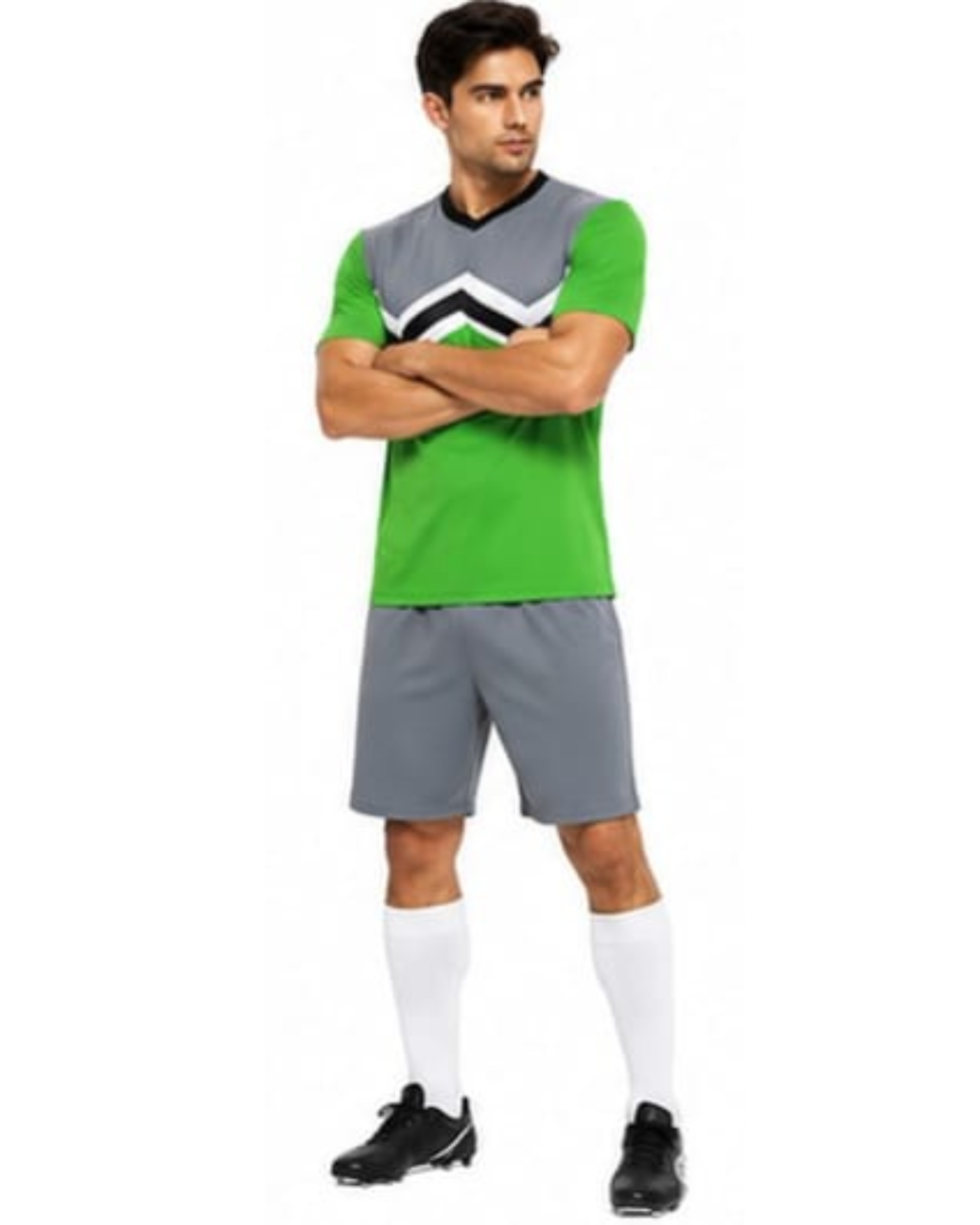 A man modeling a soccer uniform consisting of a green and gray short-sleeve jersey with a black and white chevron pattern, gray shorts, white knee-high socks, and black cleats, set against a plain white background.