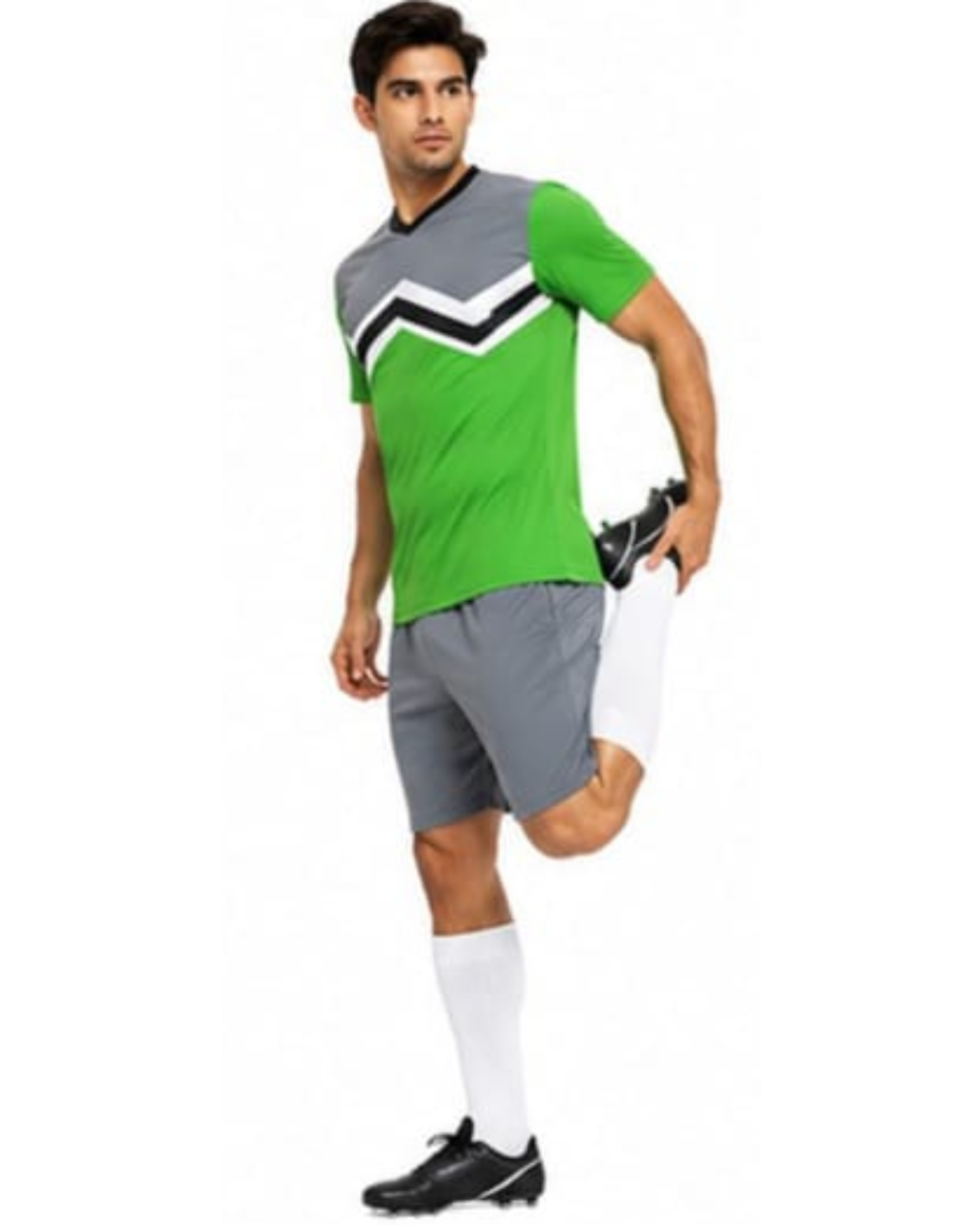 A man modeling a green and gray athletic soccer jersey with a black and white chevron pattern, paired with gray shorts, white socks, and black cleats, against a plain white background.