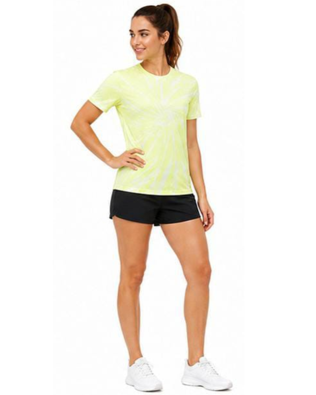 A woman modeling a neon yellow-green athletic t-shirt with a subtle spiral pattern, paired with black athletic shorts and white sneakers, against a plain white background.