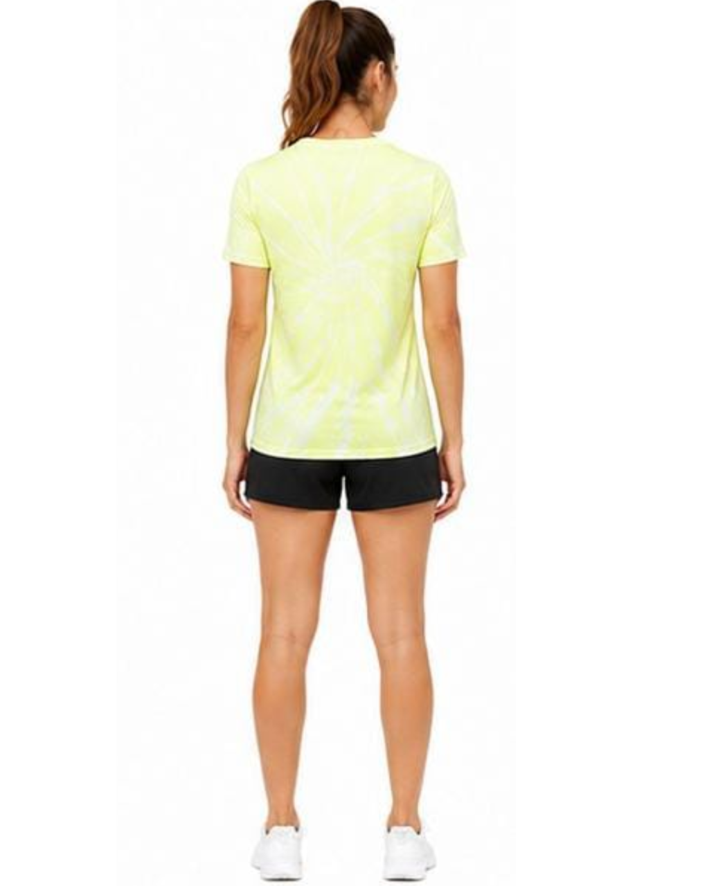 A woman viewed from the back wearing a neon yellow-green tie-dye t-shirt, black athletic shorts, and white sneakers against a plain white background.