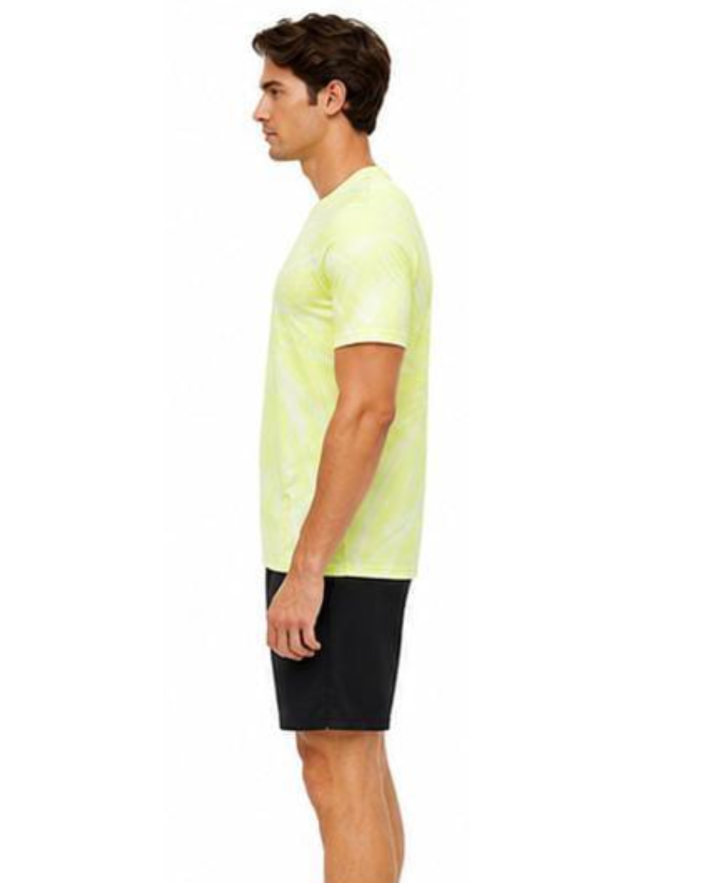 A man shown in profile wearing a neon yellow-green tie-dye t-shirt and black athletic shorts against a plain white background.