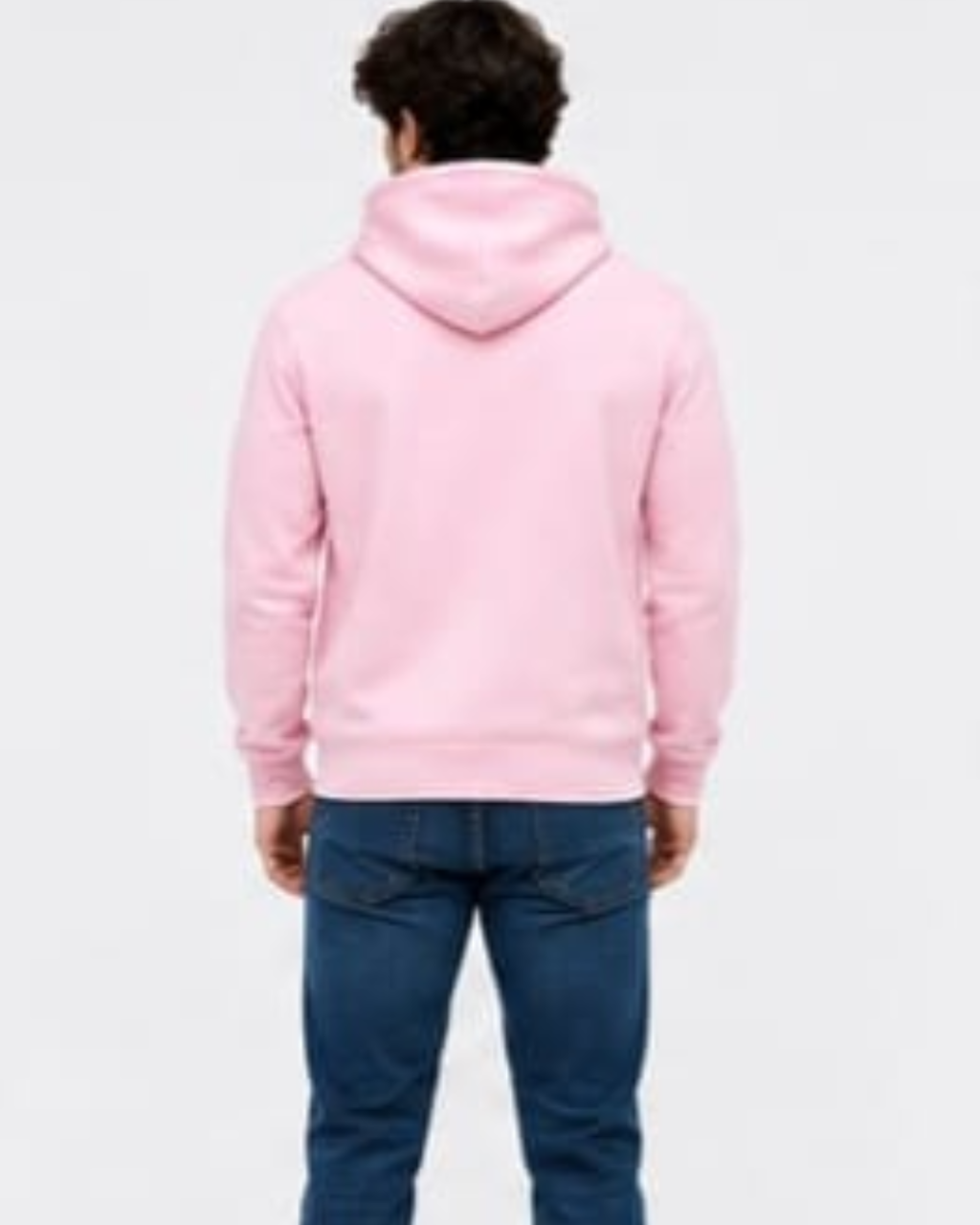 A man viewed from behind wearing a light pink pullover hoodie and blue jeans against a plain white background.