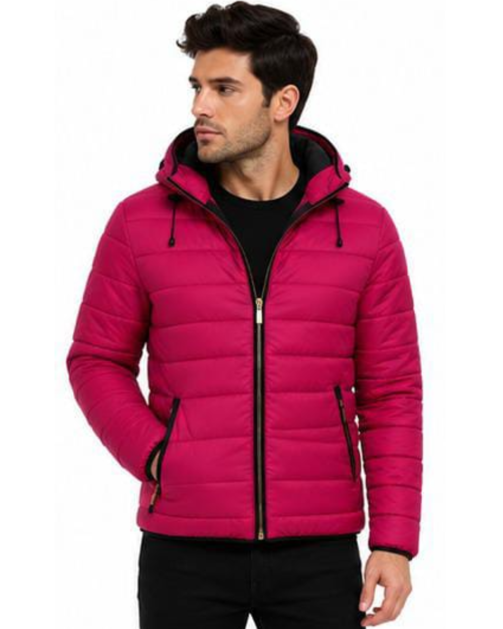 A man wearing a bright pink hooded puffer jacket with black trim and a black zip closure, layered over a black shirt and black pants, set against a plain white background.