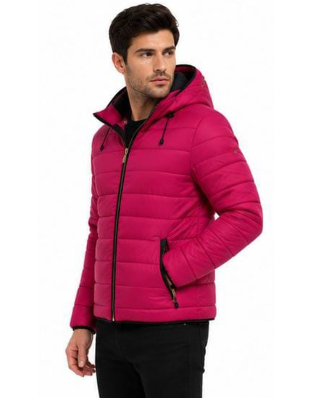 A man wearing a bright pink hooded puffer jacket with black zippers and a black interior lining, paired with black pants, against a plain white background.