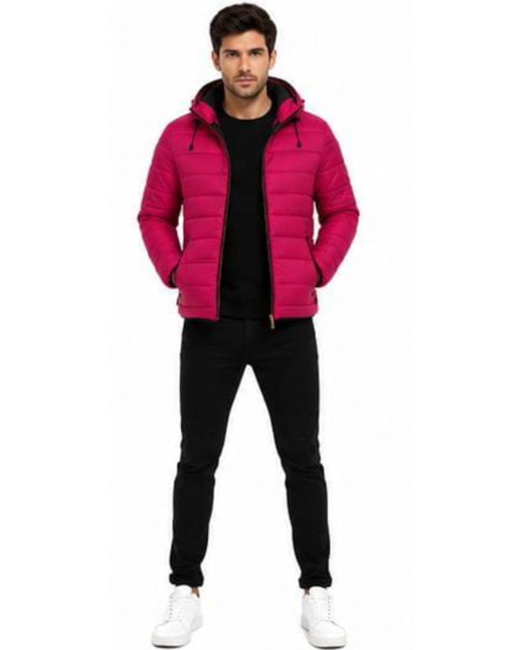A man modeling a bright pink puffer jacket with a black zipper and black hood lining, worn over a black shirt and black pants, on a plain white background.