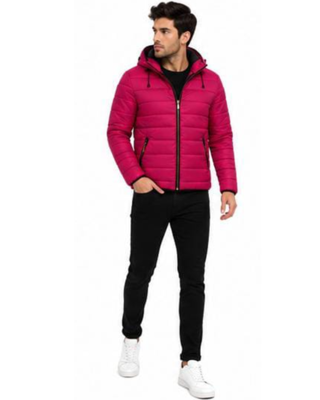 A man wearing a bright pink puffer jacket with a black zipper and black hood lining, paired with black pants and white sneakers, standing against a plain white background.