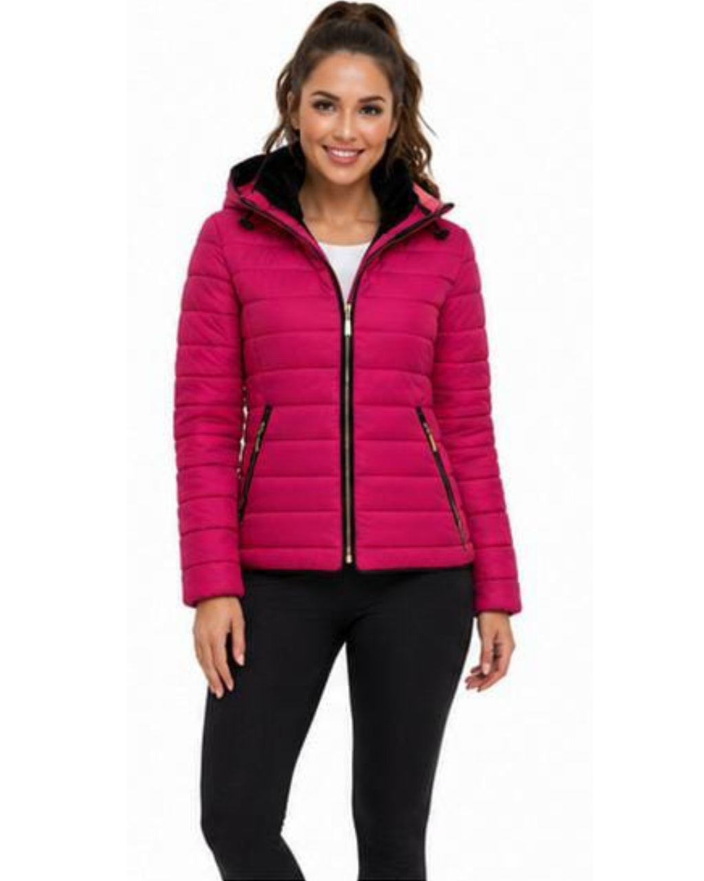 A woman modeling a bright pink hooded puffer jacket with black trim and a black zipper, paired with black leggings, against a plain white background.
