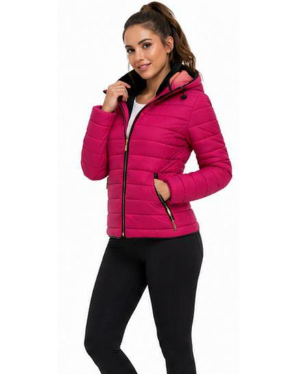 A woman wearing a bright pink puffer jacket with a black zipper and black hood lining, paired with black leggings, against a plain white background.