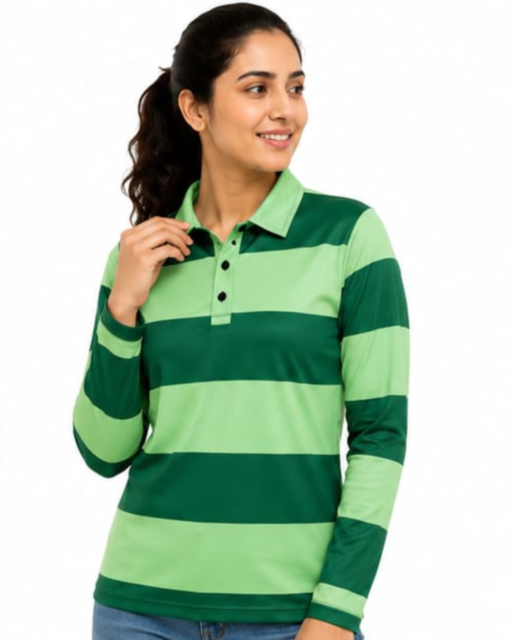 A woman wearing a green and light green horizontally striped long-sleeve polo shirt, paired with blue jeans, against a plain white background.