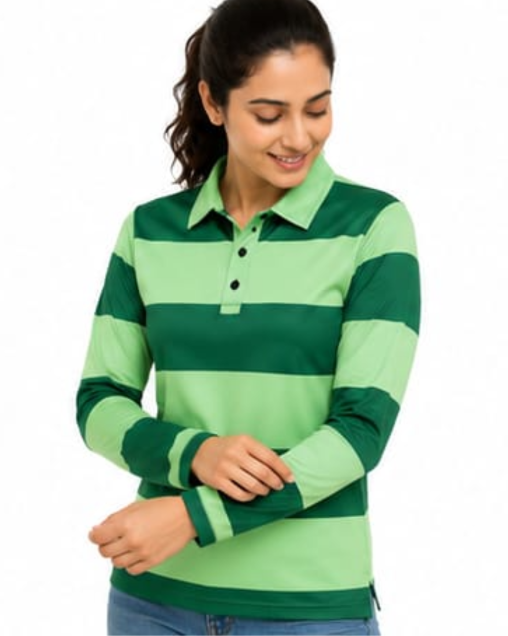 A woman wearing a green and light green horizontally striped long-sleeve polo shirt, paired with blue jeans, against a plain white background.