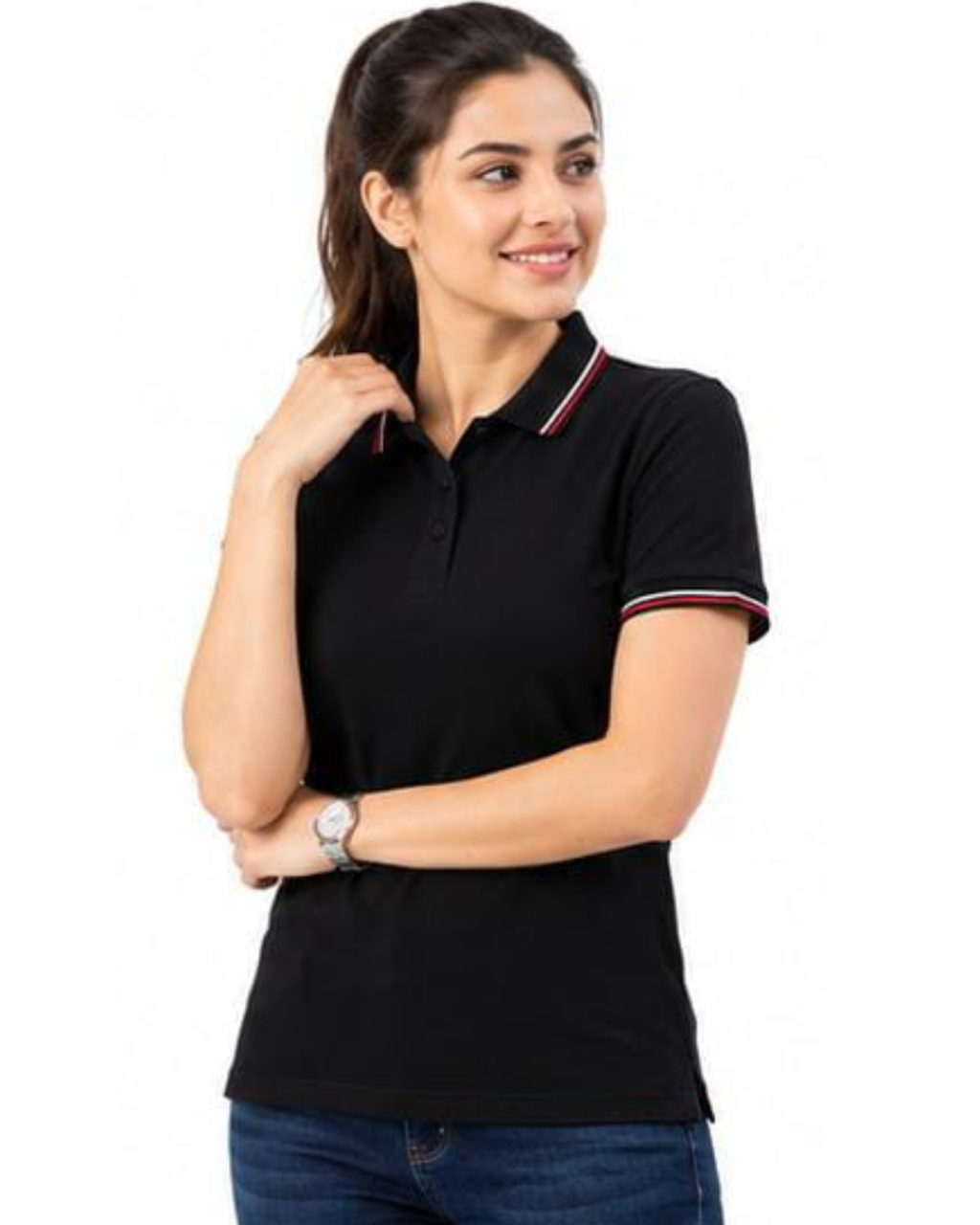 A woman modeling a black short-sleeve polo shirt with red and white striped trim on the collar and sleeve cuffs, paired with blue jeans against a plain white background.