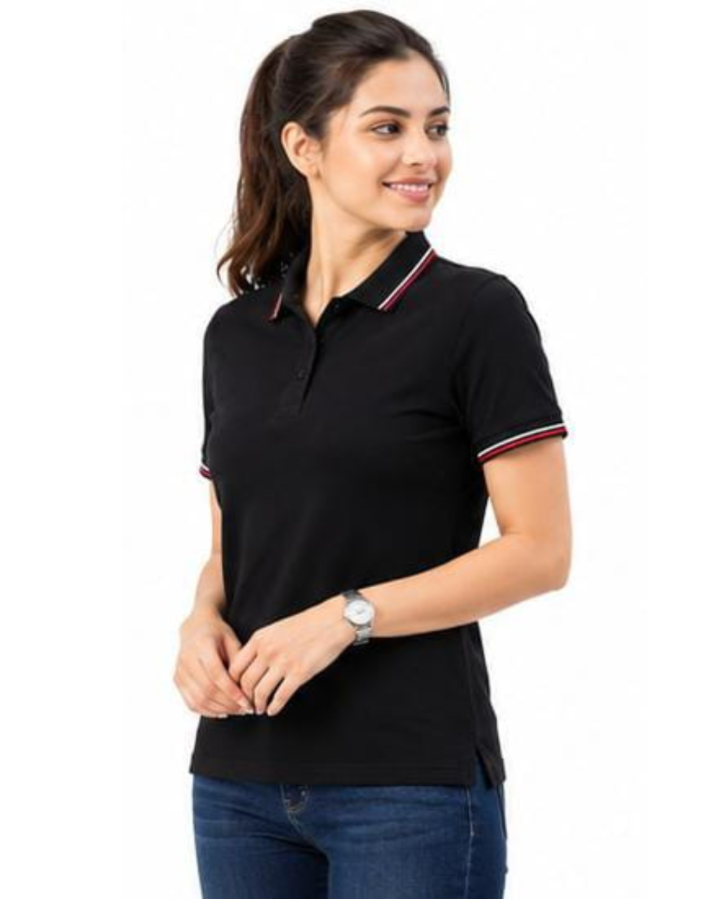A woman modeling a black short-sleeve polo shirt with red and white striped trim on the collar and sleeve cuffs, paired with blue jeans against a plain white background.