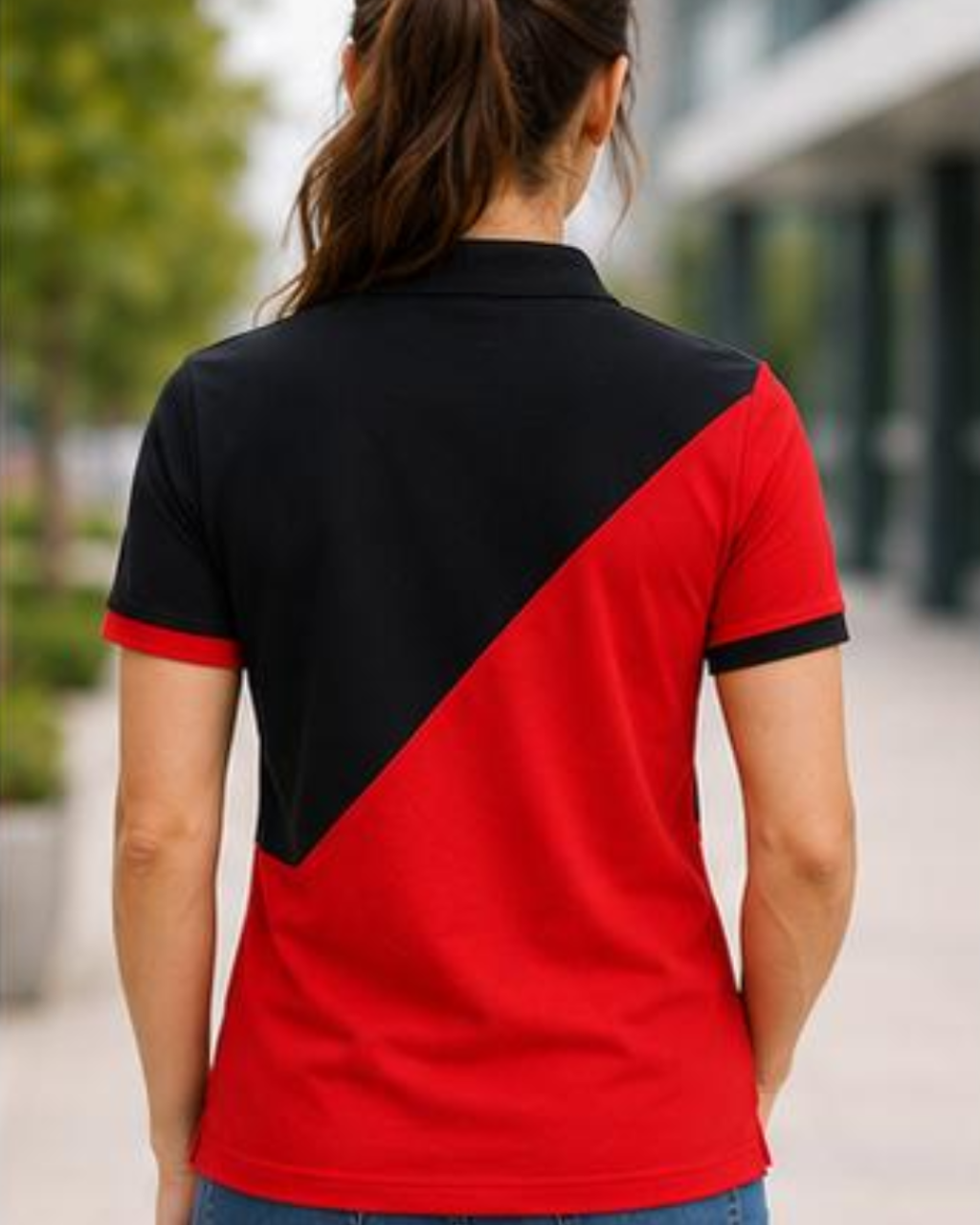 Person wearing a black and red polo shirt outdoors.
