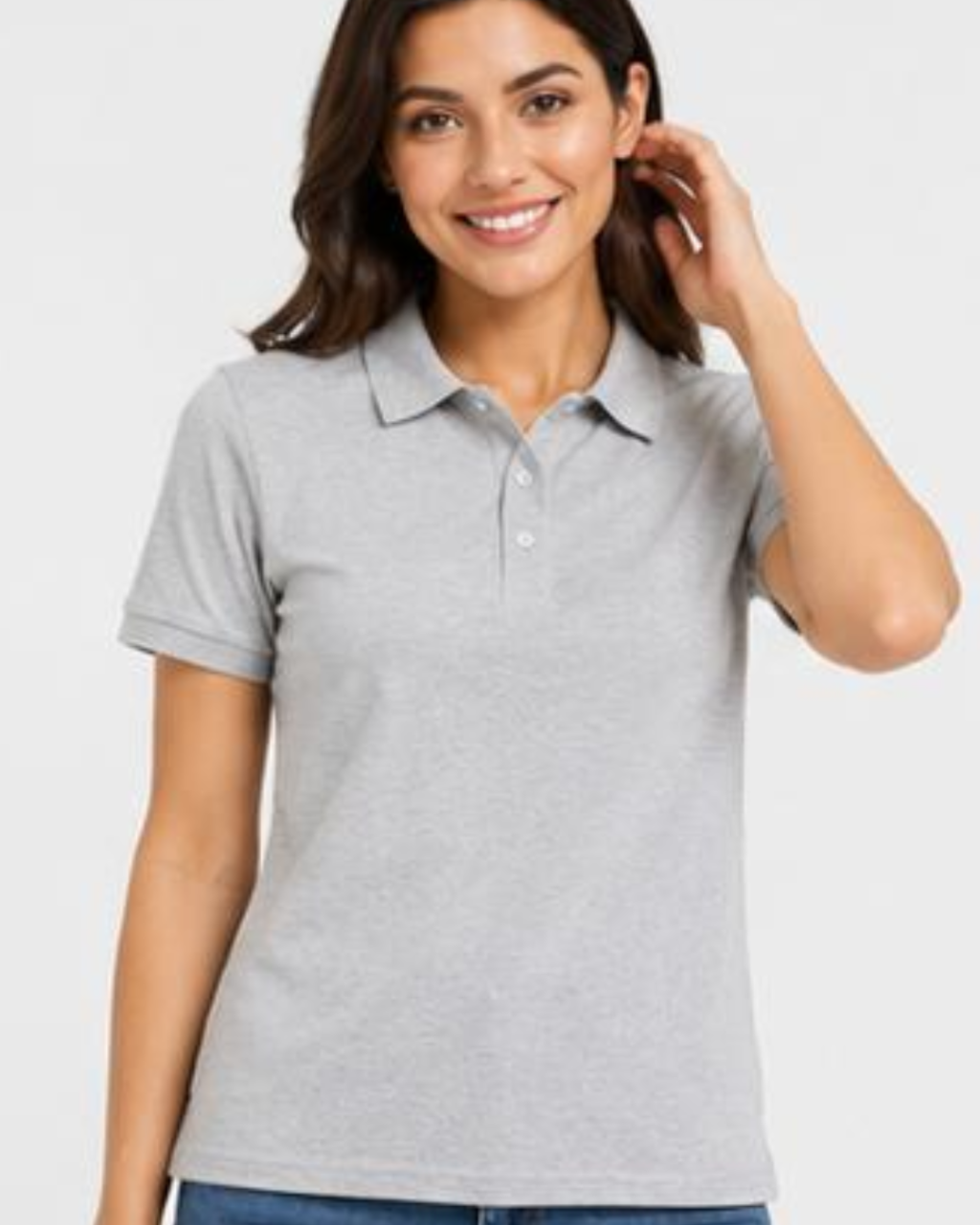 A woman wearing a light gray short-sleeve polo shirt, shown from the waist up against a plain light gray studio background.