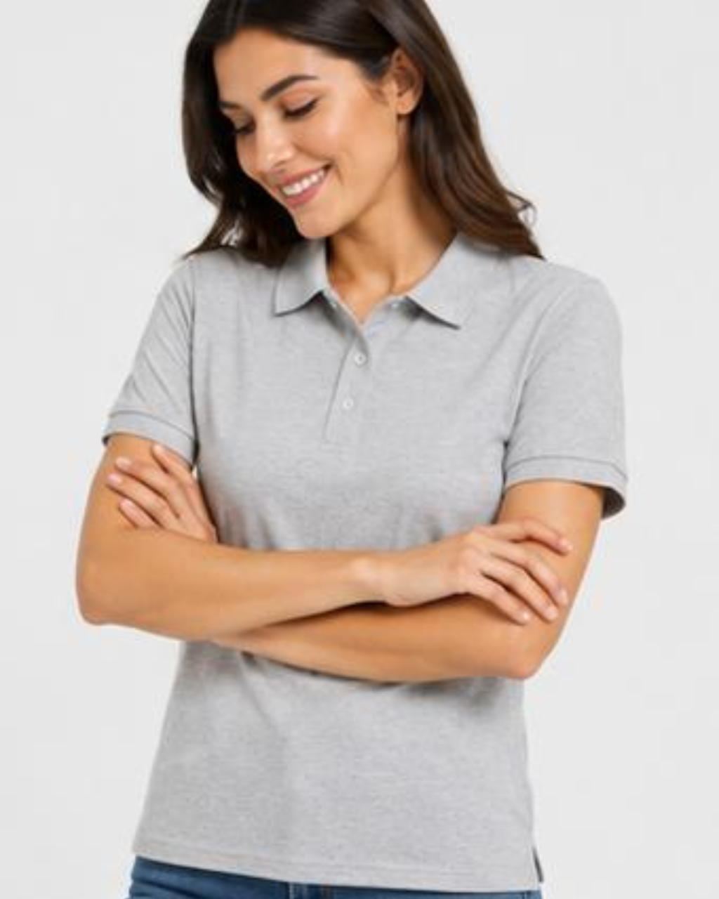 A woman wearing a light gray short-sleeve polo shirt, shown from the waist up against a plain light gray studio background.