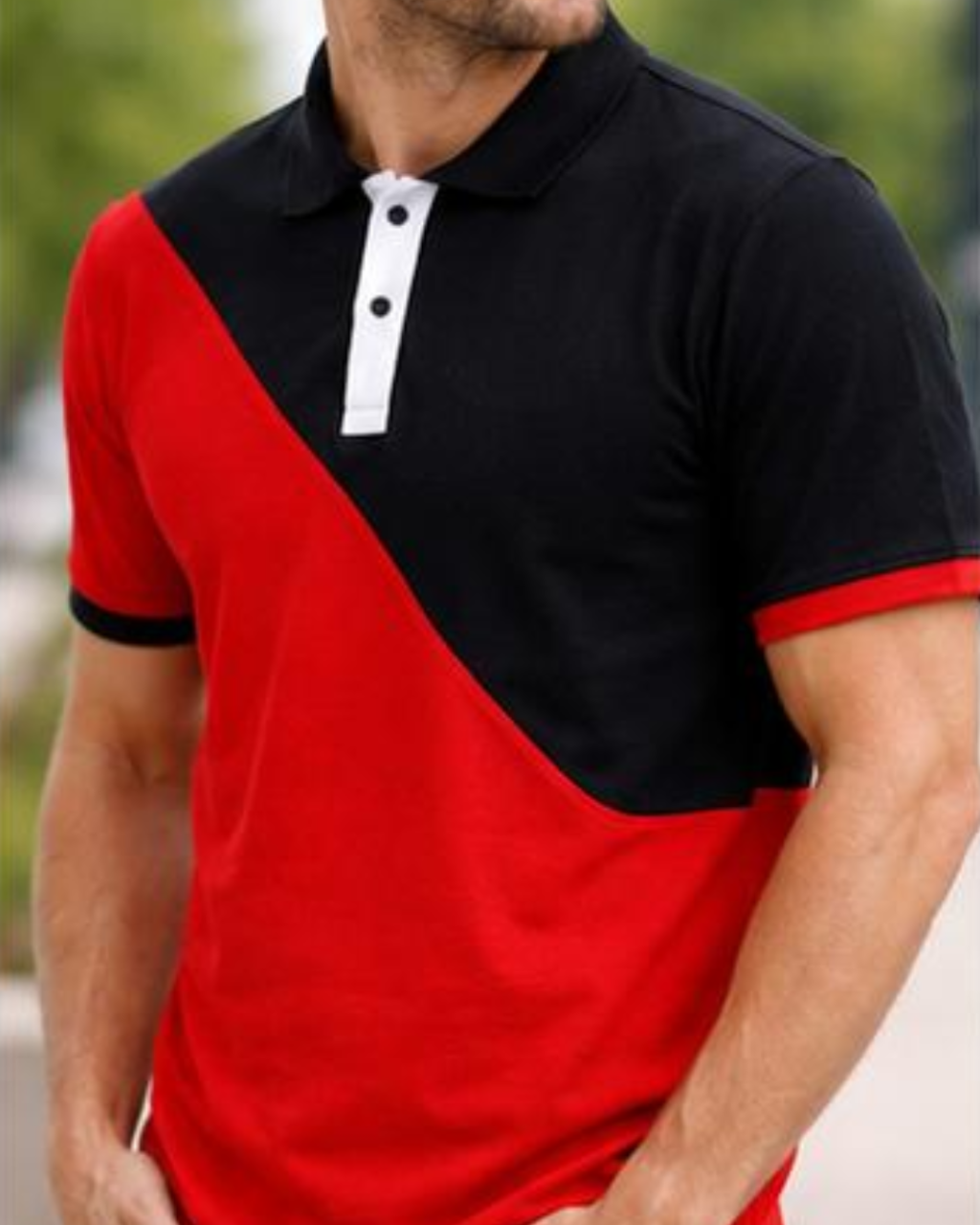 Red and black polo shirt worn by a person with a blurred background