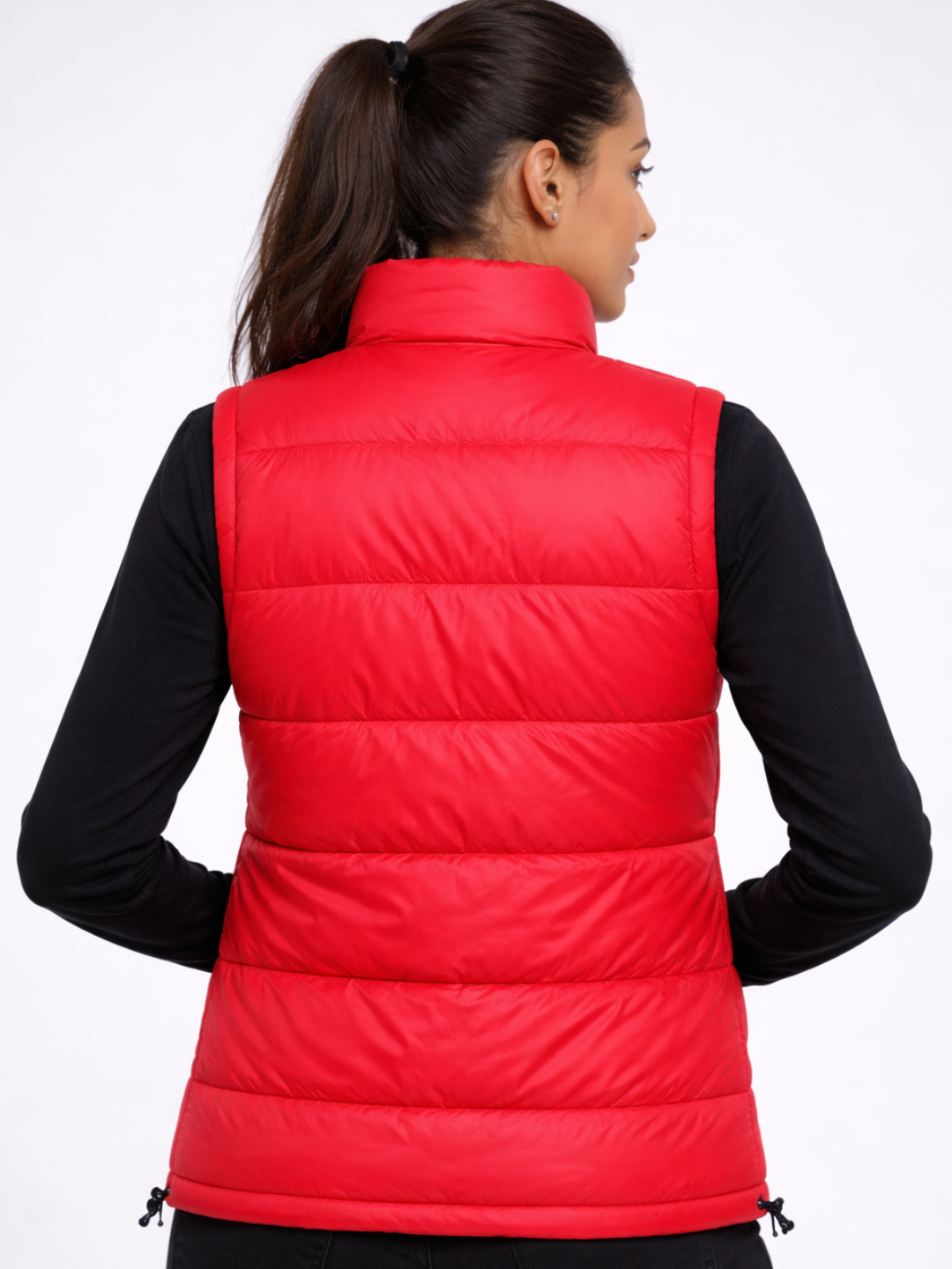 Person wearing a red puffer vest on a white background