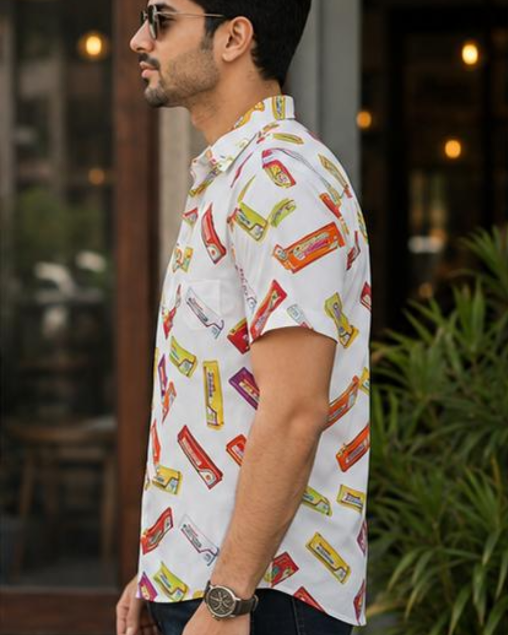 Man wearing a white shirt with candy bar pattern outdoors