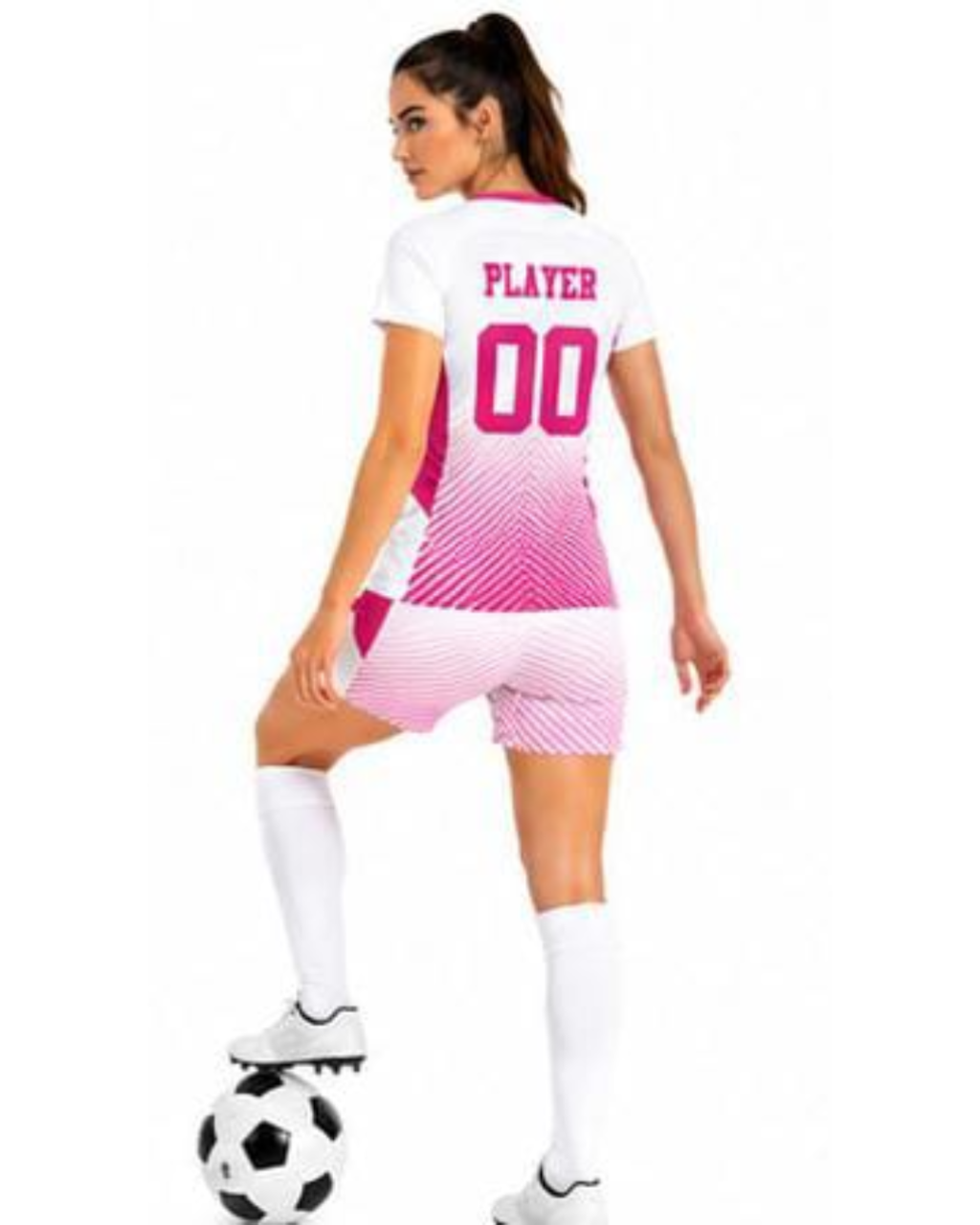 A woman modeling a white and pink soccer jersey and matching shorts, shown from the back with the name 'PLAYER' and number '00' printed on the back. She is wearing white socks and standing on a soccer ball against a plain white background.