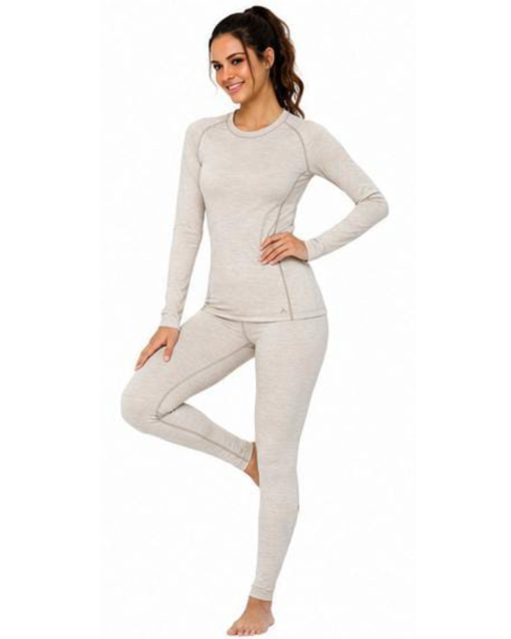 A woman modeling a light heather gray long-sleeve crewneck top and matching leggings against a plain white background.