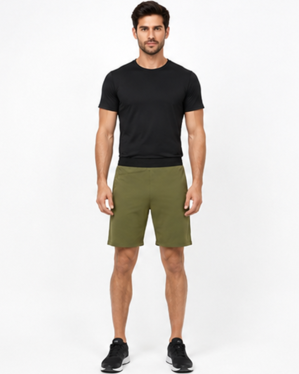 A man modeling a black short-sleeve crewneck t-shirt and olive green athletic shorts against a plain white studio background.