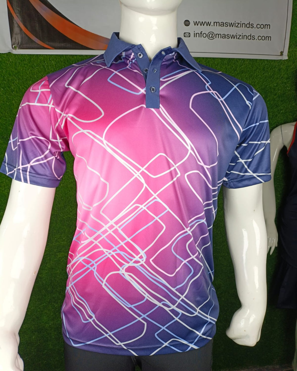 A short-sleeve polo shirt displayed on a white mannequin torso. The shirt features a vibrant pink-to-purple gradient with an abstract white line pattern and a solid blue collar and button placket.