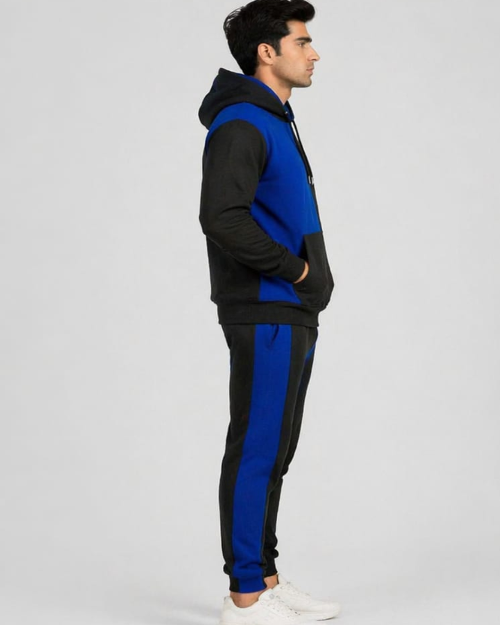 Person wearing a black and blue tracksuit on a white background