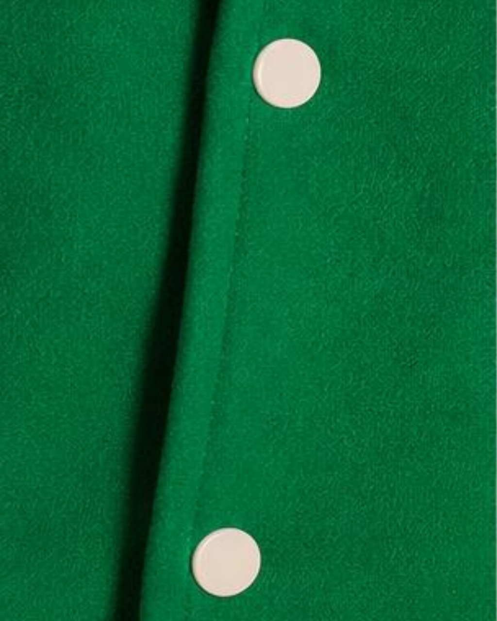 Close-up of a green fabric with a button detail