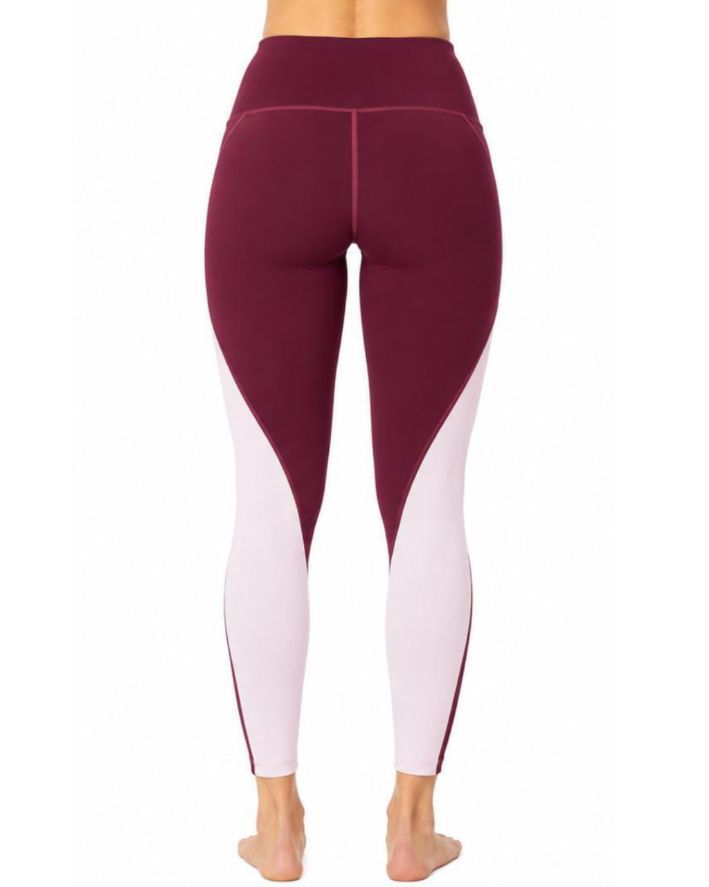 Rear view of a person wearing high-waisted colorblock leggings in burgundy and light pink, shown against a plain white background.