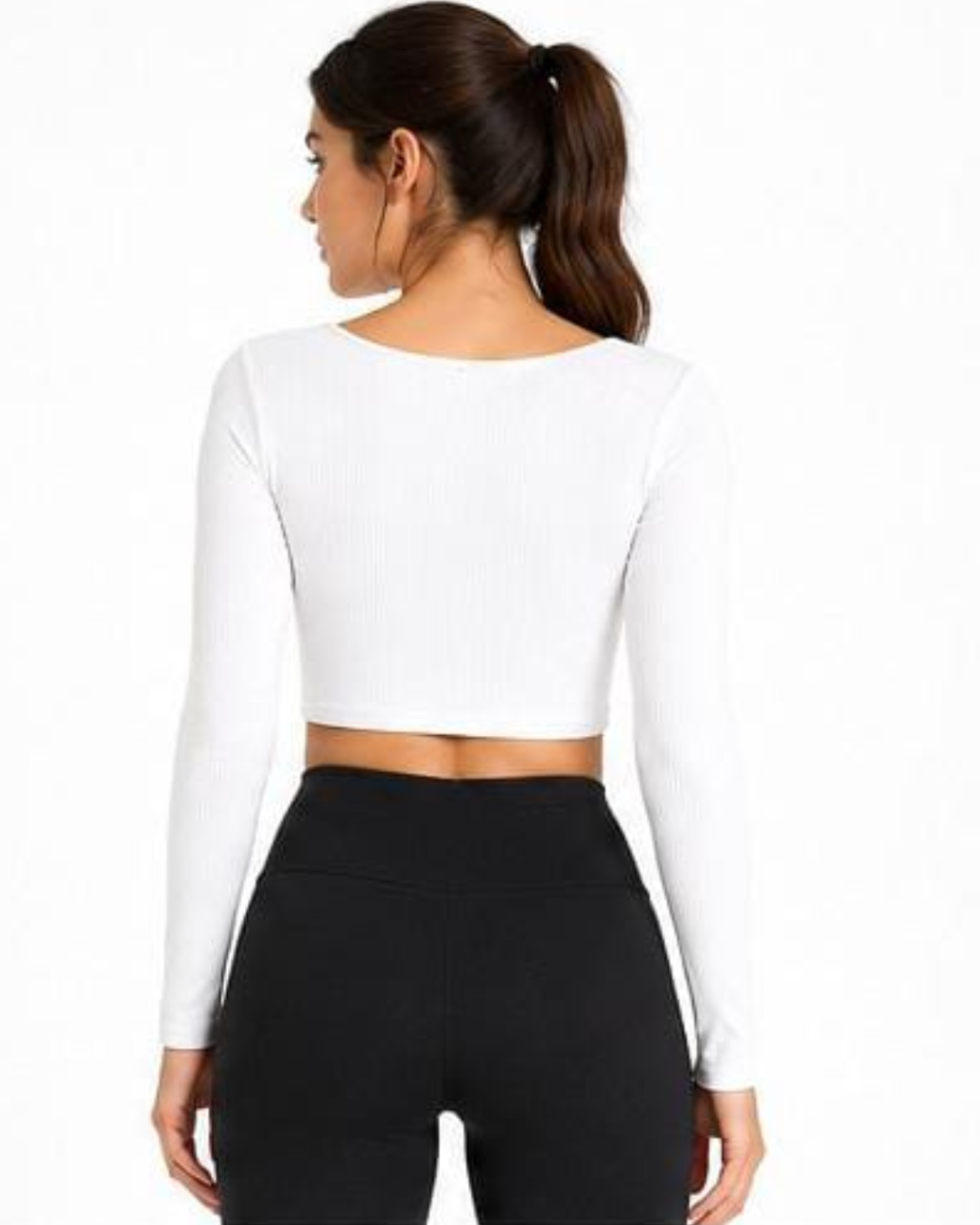 A woman shown from the back wearing a white long-sleeve ribbed crop top and black leggings against a plain white background.