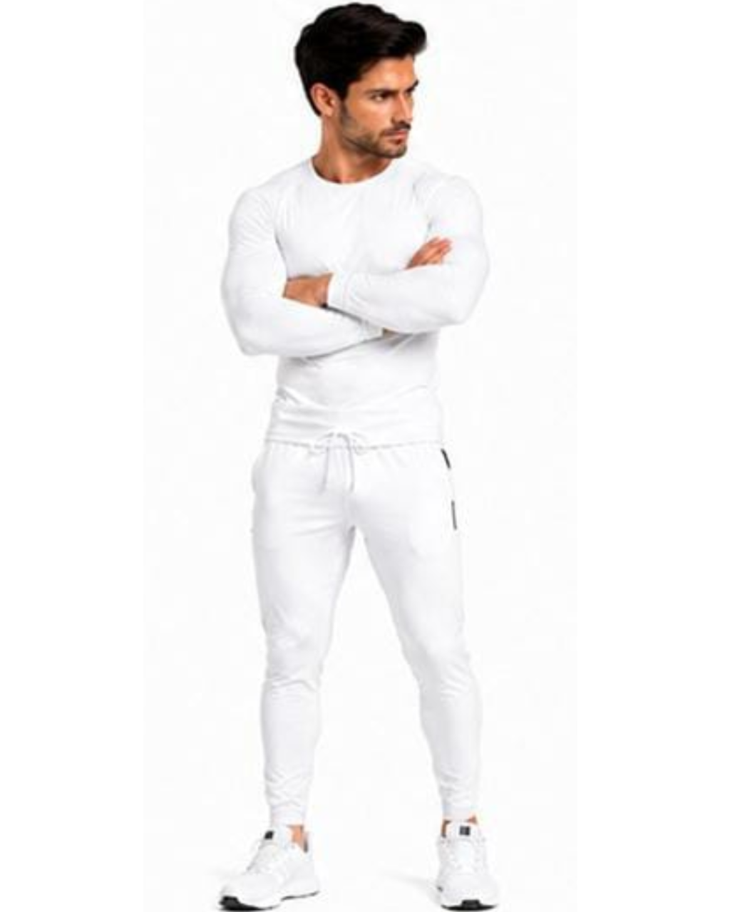 A man modeling a white long-sleeve athletic top and matching white jogger pants with white sneakers, standing against a plain white background.