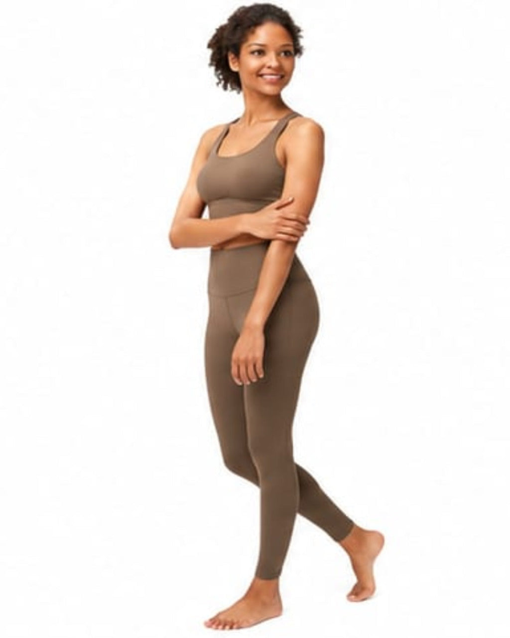 Woman wearing a brown tank top and leggings on a white background