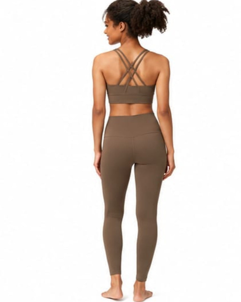Woman wearing a brown sports bra and leggings set on a white background