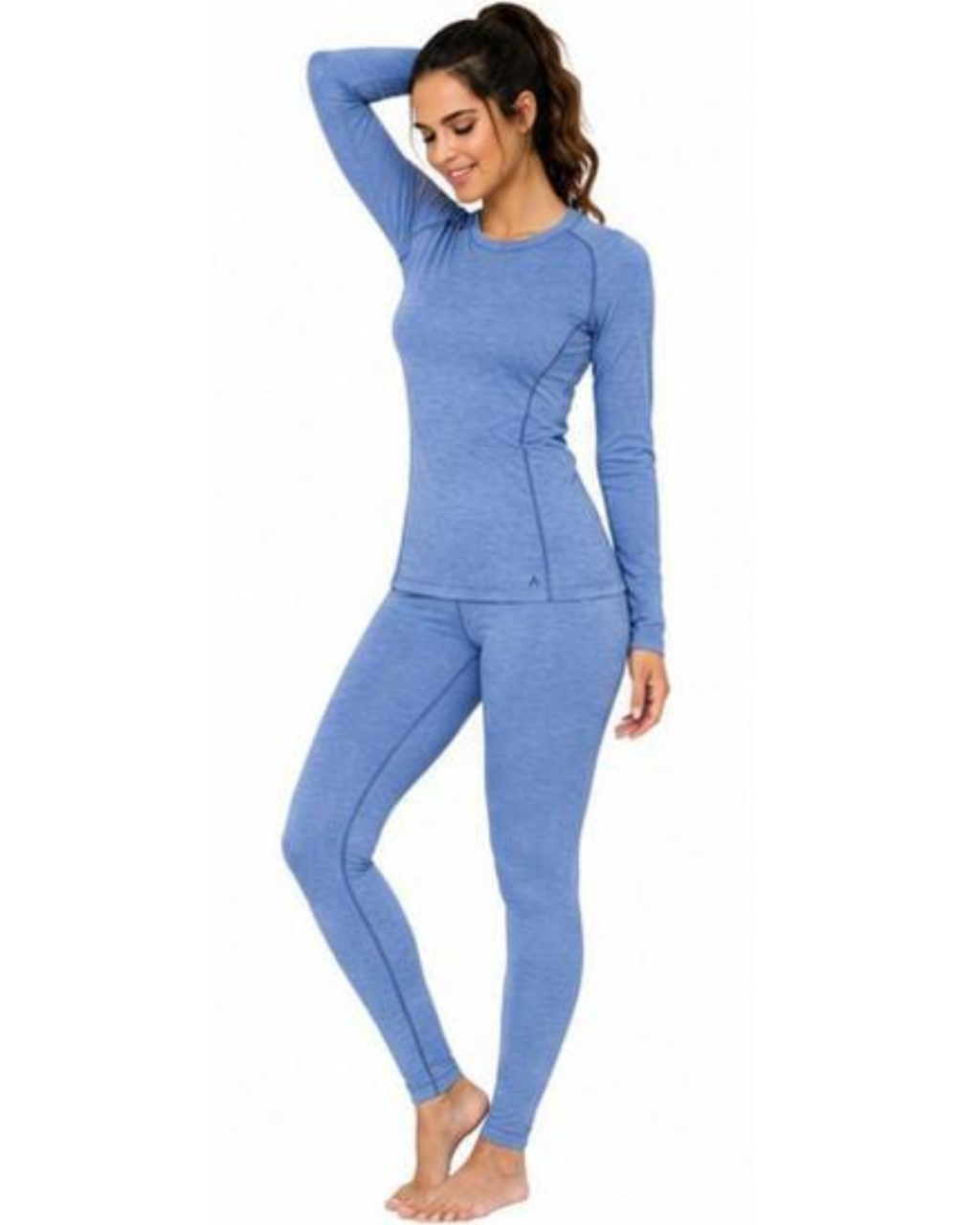 A woman modeling a matching two-piece long-sleeve athletic pajama set in heathered periwinkle blue, featuring a crewneck top and full-length leggings, set against a plain white background.