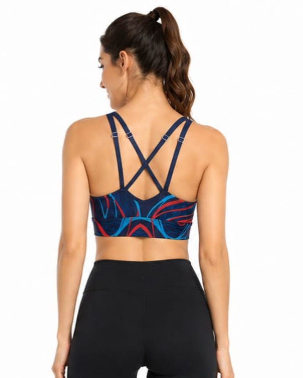 A woman shown from the back wearing a sports bra with a navy, blue, and red abstract pattern and black leggings, against a plain white background.