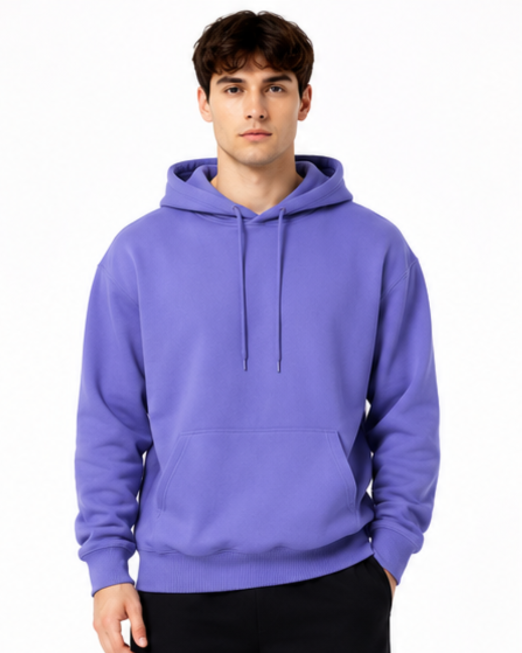 A man wearing a solid purple pullover hoodie with drawstrings and a front kangaroo pocket, paired with black pants, against a plain white background.