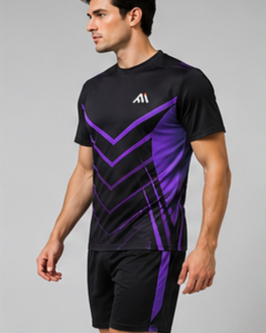 A man wearing a black athletic t-shirt with purple geometric patterns and matching black athletic shorts, shown against a plain gray studio background.