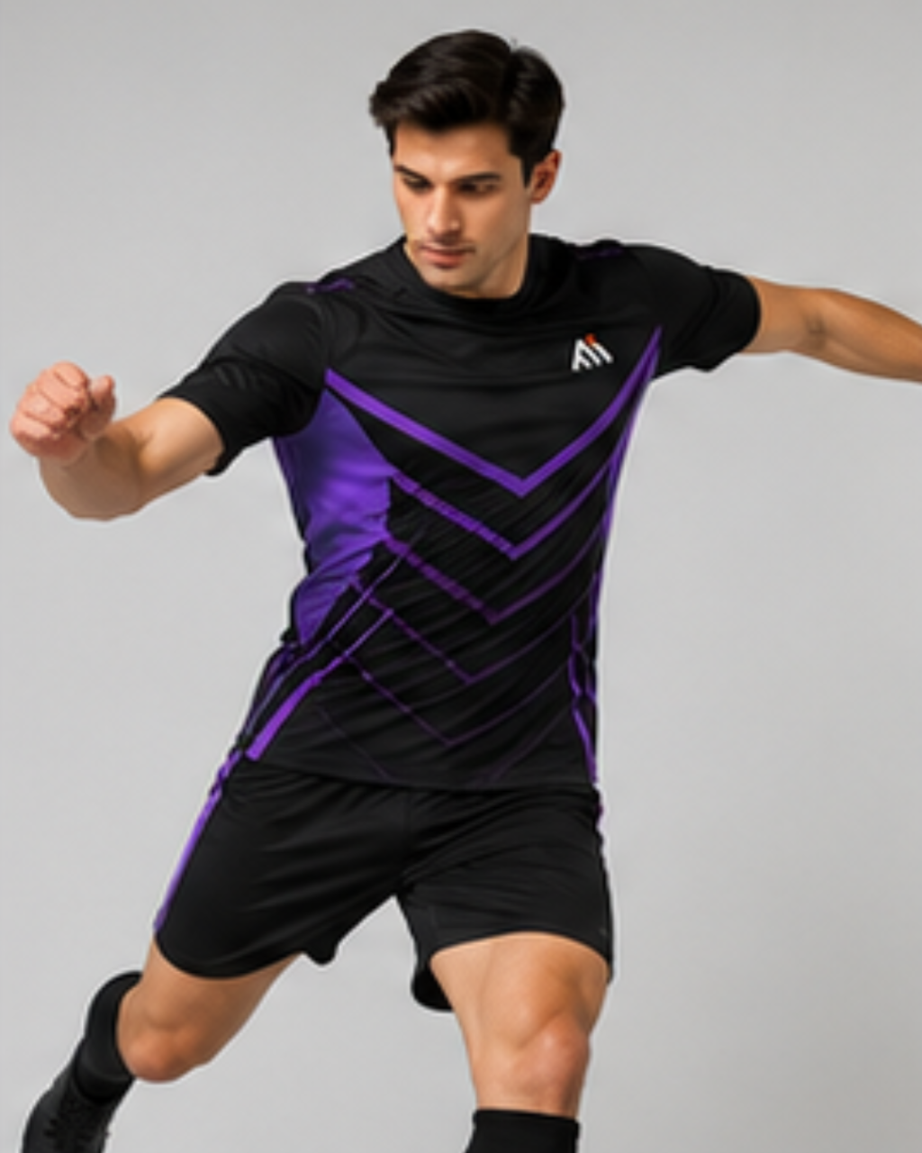 A man in athletic wear, featuring a black short-sleeve athletic jersey with purple geometric chevron patterns and black shorts, captured mid-action against a solid gray studio background.