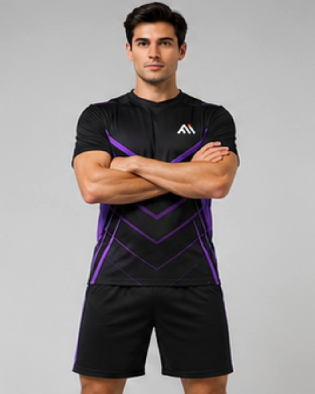 A man modeling a black athletic t-shirt with purple geometric accents and matching black shorts against a solid gray background.