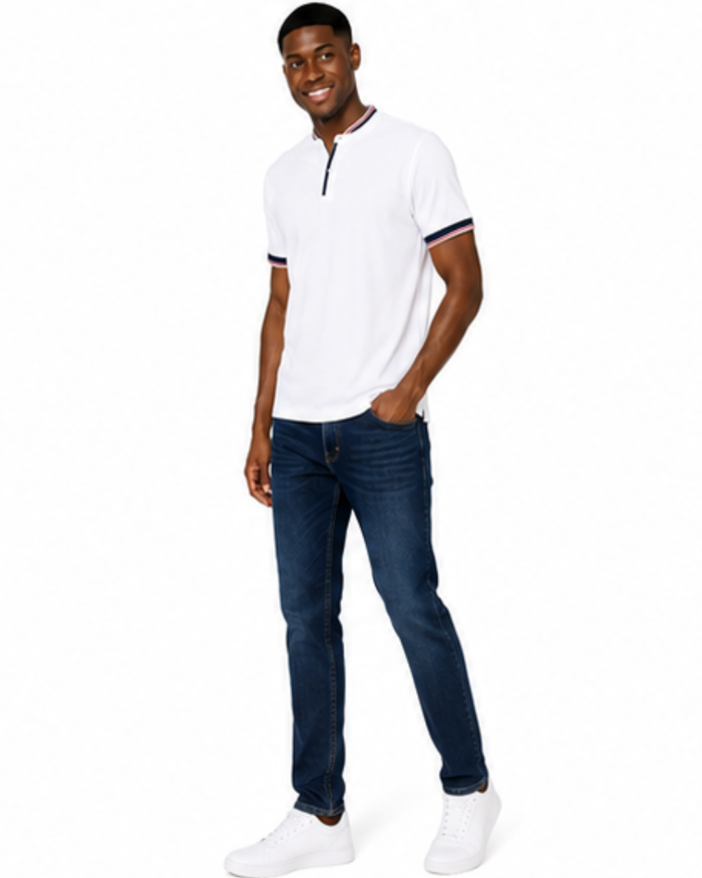 A man wearing a white short-sleeve polo shirt with navy and red striped trim on the collar and cuffs, paired with dark blue jeans and white sneakers, standing against a plain white background.