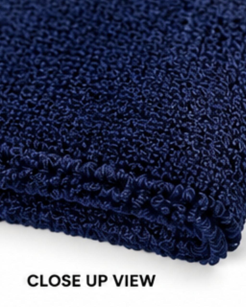 Close-up view of a folded dark navy blue textured rug or carpet showing the loop pile texture, with the text 'CLOSE UP VIEW' at the bottom on a white background.