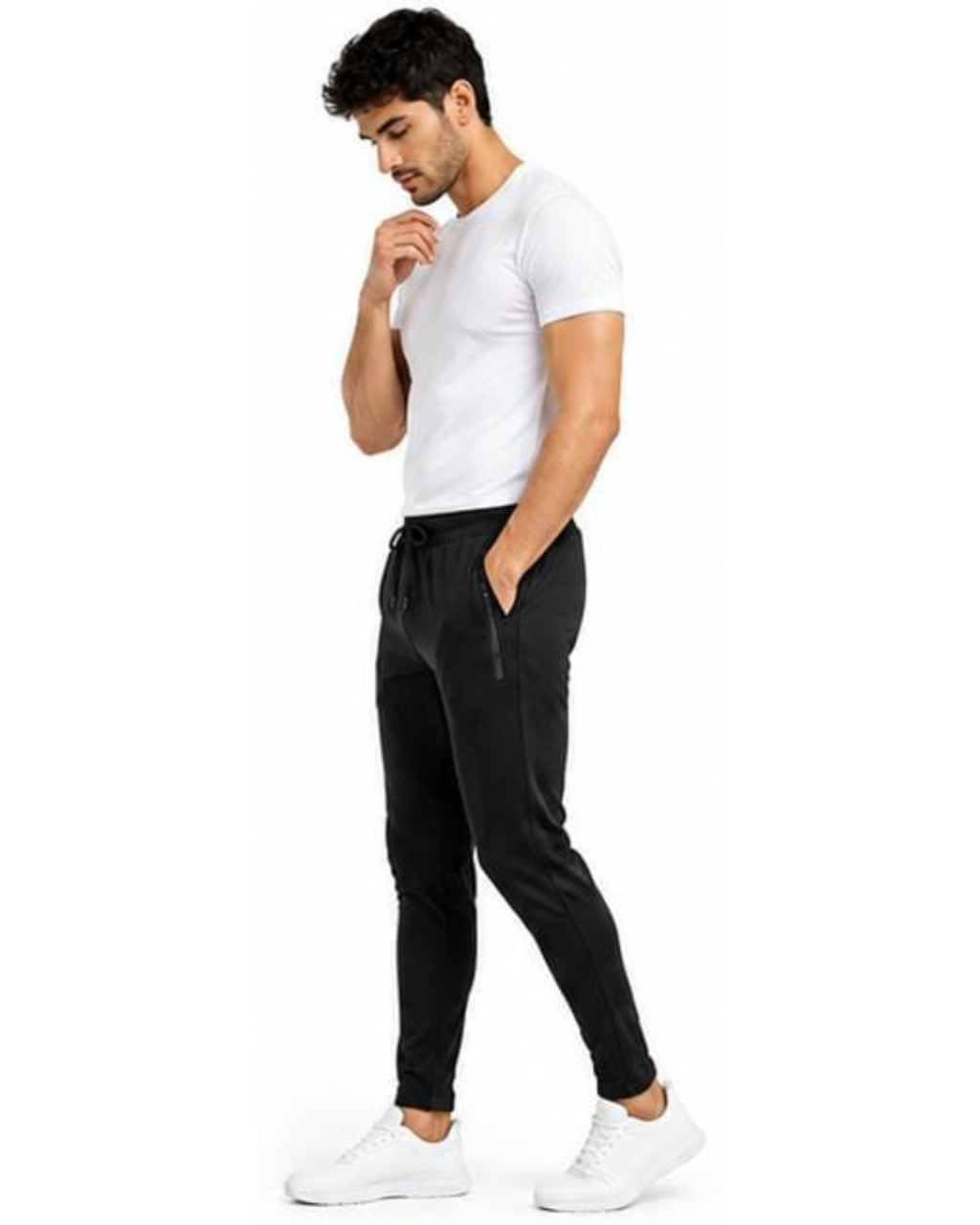 A man wearing a white crew-neck t-shirt, black jogger pants with a drawstring waist, and white sneakers, standing in profile against a solid white background.